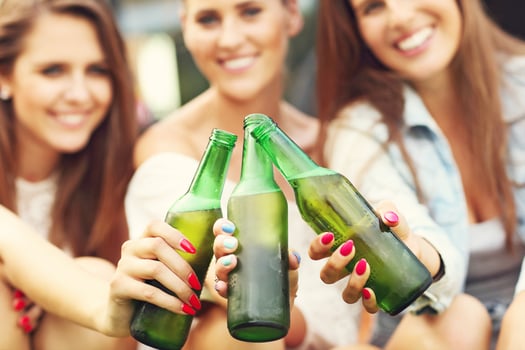 Happy group of friends drinking beer outdoors photo