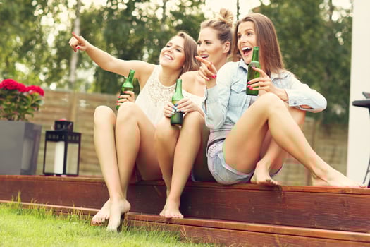 Happy group of friends drinking beer outdoors photo