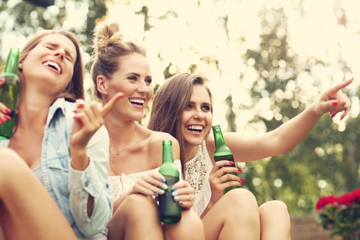 Happy group of friends drinking beer outdoors photo