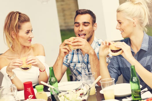 Group of friends eating hamburgers photo