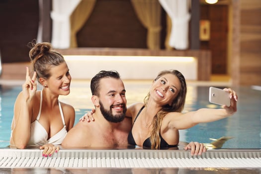 Group of friends relaxing in pool spa photo