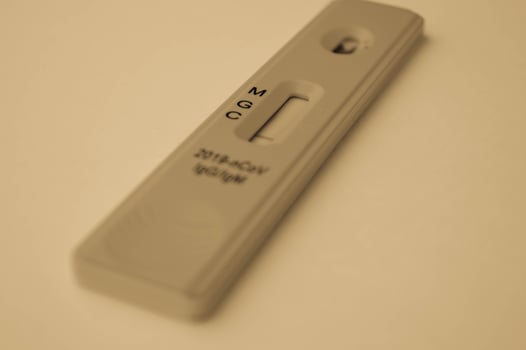 test for coronavirus lies on a black and white background. a drop of blood on a test strip. rapid diagnosis of coronavirus, laboratory test. medical research to identify the virus photo
