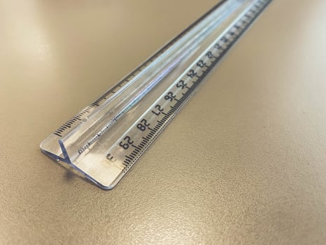 a transparent, long, centimeter ruler lies on the table. supplies for mathematics and geometry. stationery and office supplies for work photo