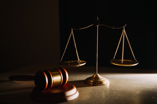 Business and lawyers discussing contract papers with brass scale on desk in office. Law, legal services, advice, justice and law concept photo