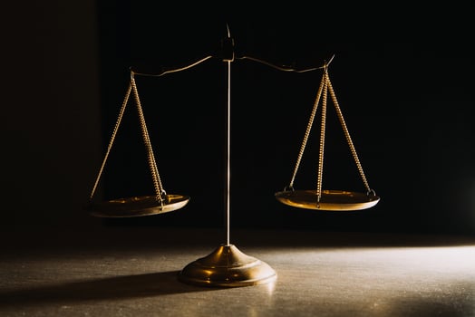 Business and lawyers discussing contract papers with brass scale on desk in office. Law, legal services, advice, justice and law concept picture with film grain effect photo