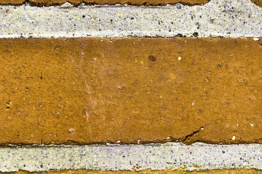 Detailed view at a colorful old and weathered brick wall texture as a panoramic background. photo