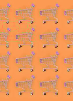 Shopping addiction, shopping lover or shopaholic concept. Many small empty shopping carts perform a pattern on a pastel colored paper background. Flat lay composition, top view photo