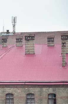 Fragment of a metal roof of the restored old multi-storey building in Lviv, Ukraine photo