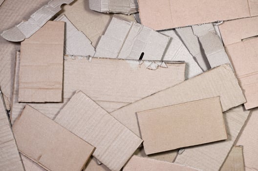 Background image with a lot of beige cardboard paper, which is used to make boxes for the transport of home appliances and postal parcels. Carton texture photo