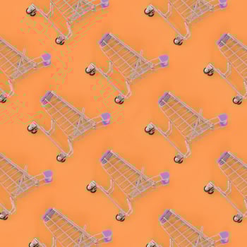 Shopping addiction, shopping lover or shopaholic concept. Many small empty shopping carts perform a pattern on a pastel colored paper background. Flat lay composition, top view photo