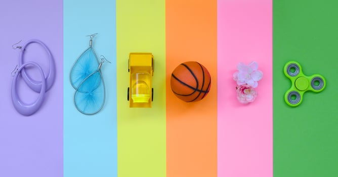 Trendy fashionable pastel composition with earrings, sunglasses, beverage can, basketball ball, toy truck, flower and spinner on background of pink, violet, green, orange, yellow and blue colors photo