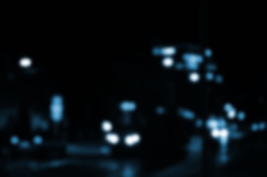 Blurred night scene of traffic on the roadway. Defocused image of cars traveling with luminous headlights. Bokeh Art photo