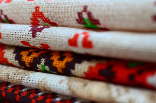 Stack of traditional Ukrainian folk art knitted embroidery patterns on textile fabric photo