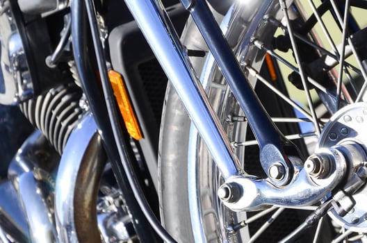Fragment of chromed shiny wheel of old classic motorbike photo