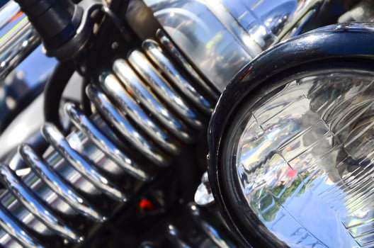 Fragment of chromed shiny lamp of old classic motorbike photo
