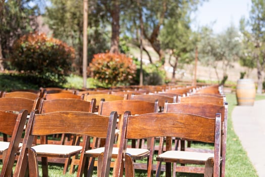 Rows of Wooden Event Chairs at Wedding Venue Abstract. photo