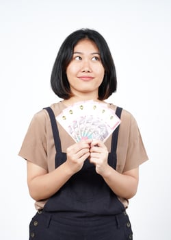 Holding Indonesia New 100.000 Banknote Of Beautiful Asian Woman Isolated On White Background photo