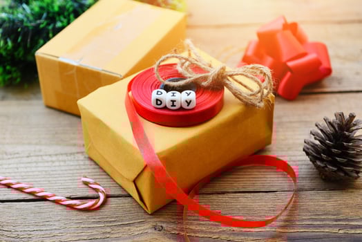 diy gift concept - Homemade wrapped christmas presents with tools and decorations on wooden , DIY hobby gift box wrapped brown paper collection in for christmas or new year photo