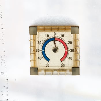 home window thermometer in warm winter day photo