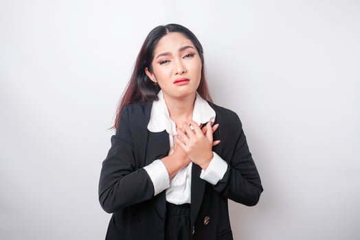 Tired upset young business woman suffering from pain, muscle spasm at workplace. Fatigue, deadline, pain and incorrect posture photo