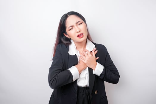 Tired upset young business woman suffering from pain, muscle spasm at workplace. Fatigue, deadline, pain and incorrect posture photo