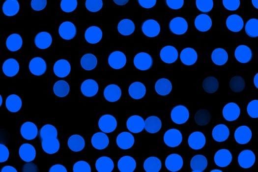 Unfocused abstract dark blue bokeh on black background. defocused and blurred many round light photo