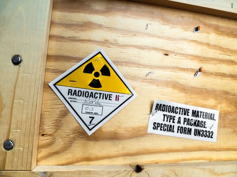 Radioactive material warning label beside the transportation wooden package photo