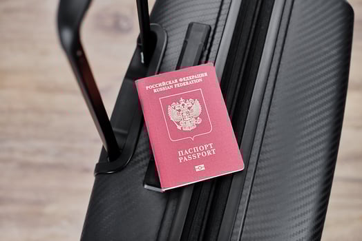 Russian passport on a black travel suitcase, top view, selective background. Emigration of Russians, seeking asylum photo