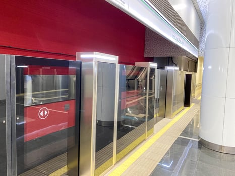 Automatic door platform system at a new modern metro station. Metro security system glass beautiful doors open synchronously with the doors of the arriving train car photo