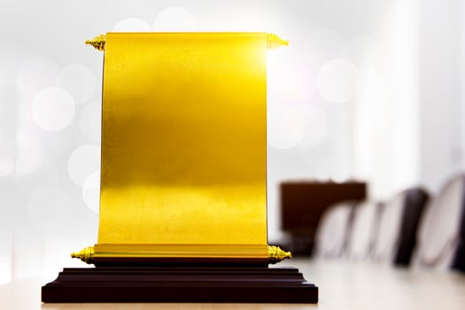 certificate, golden award badge stands out on desk. concept of Outstanding Employee Award, Winner, Successful Company Award. photo