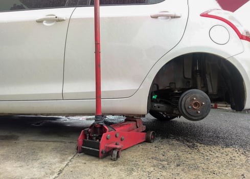 White cars change wheels using a lifting jack. photo