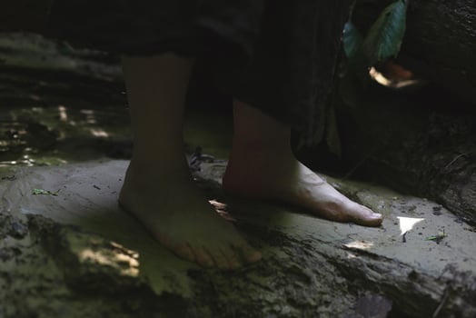 Close up bare human feet on ground concept photo