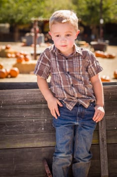 Little Boy With Hands in His Pockets at Pumpkin Patch photo