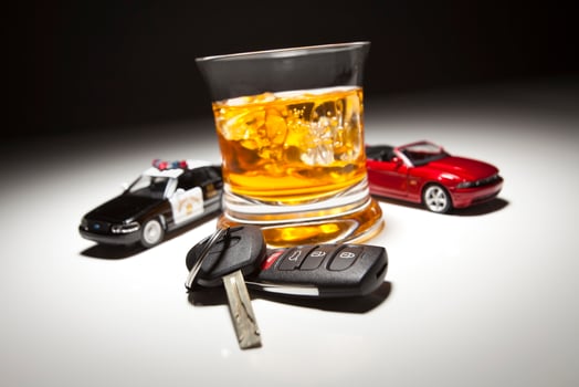Highway Patrol Police and Sports Car Next to Alcoholic Drink and Keys photo