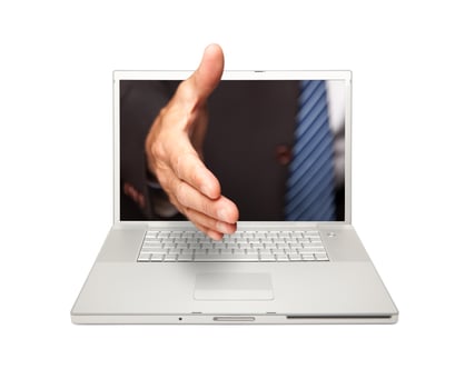 Man Reaching for a Handshake Through Laptop Screen photo