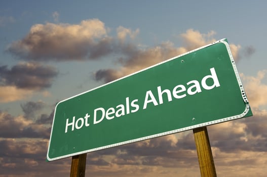Hot Deals Ahead Green Road Sign Over Clouds photo