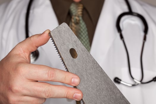Doctor with Stethoscope Holding A Sharp Saw photo