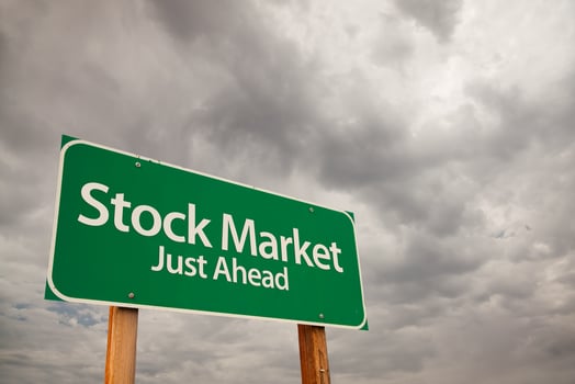 Stock Market Green Road Sign Over Storm Clouds photo