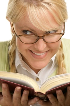 Female With Ponytails Reads Her Book photo