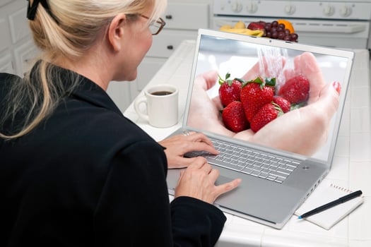 Woman In Kitchen Using Laptop - Food and Recipes photo