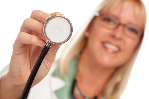 Attractive Female Doctor Holding Stethoscope photo