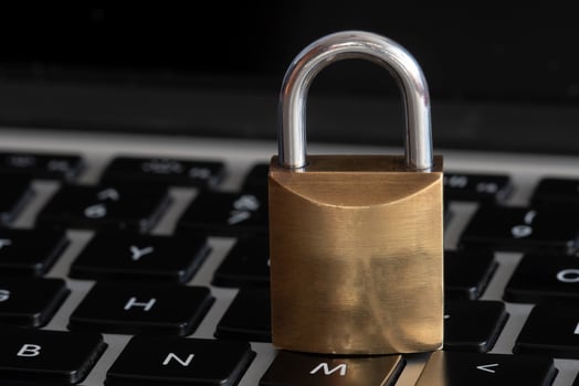 internet and computer security represented by a closed padlock over a black keyboard photo