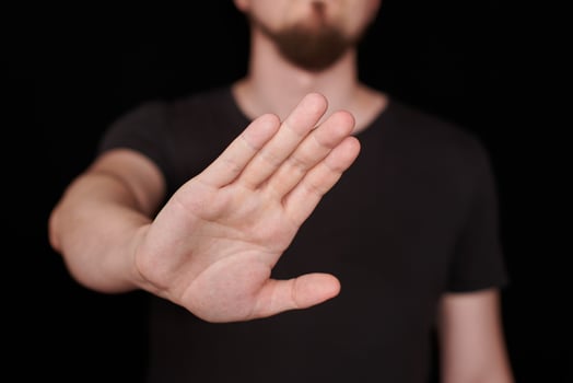 Man in black t-shirt doing stop sing photo