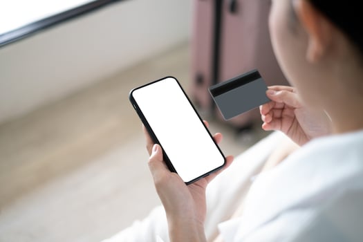 Woman using credit card to book hotel online photo