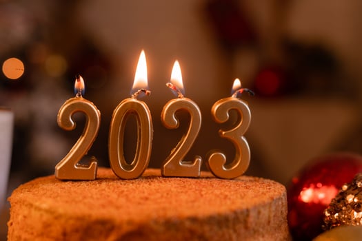 homemade honey cake in the kitchen with candles 2023. Cozy New Year at home. Merry Christmas. High quality photo