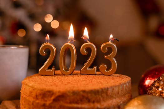 homemade honey cake in the kitchen with candles 2023. Cozy New Year at home. Merry Christmas. High quality photo