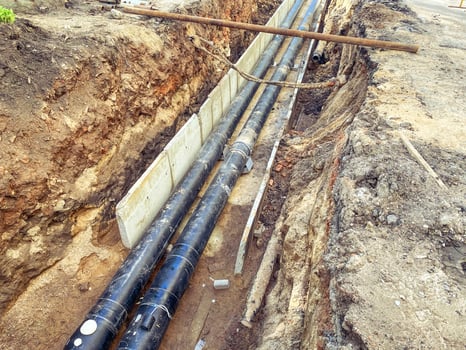 black, polypropylene, long pipes are laid underground for communications. construction of a new neighborhood photo
