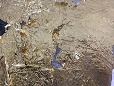 Gold glittering bright yellow metallic gold leaf texture for artistic purposes and creativity. The background photo