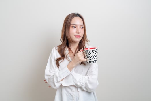 portrait beautiful Asian woman holding coffee cup or mug photo