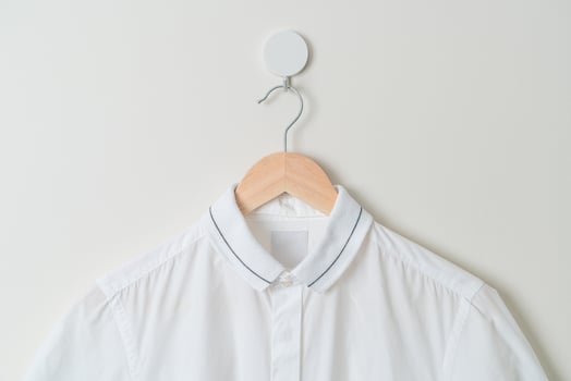 hanging shirt with wood hanger on wall photo